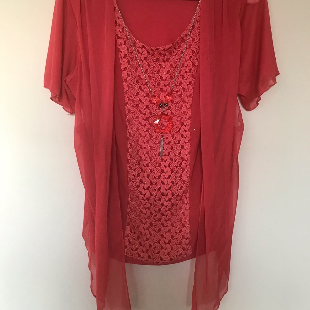 Woman’s used orange blouse extra large.